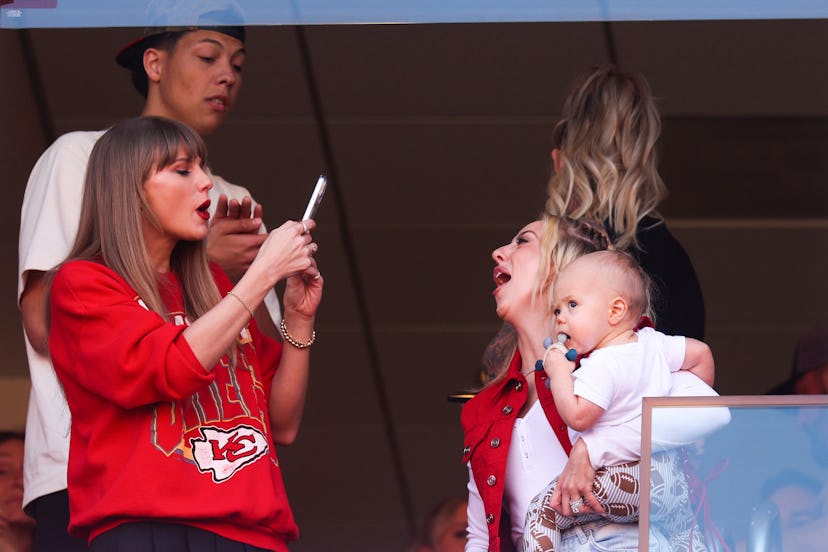 Taylor Swift and Brittany Mahomes cheering at Travis Kelce's game. 