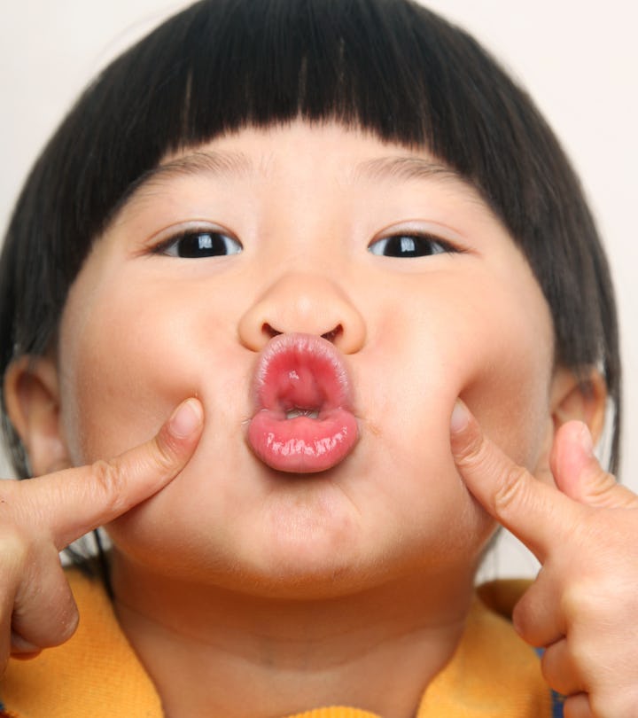 Portrait of little Asian girl blowing kiss to camera