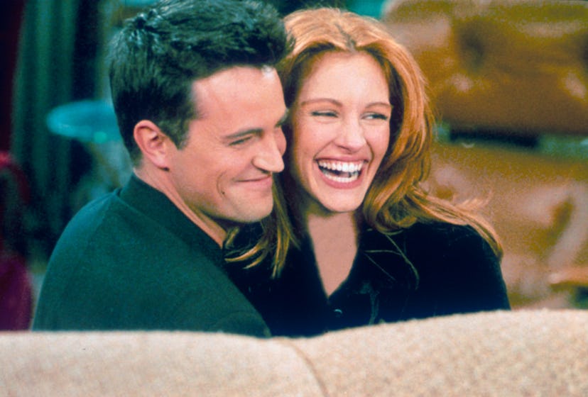 Matthew Perry and Julia Roberts hug each other on the set of "Friends." 