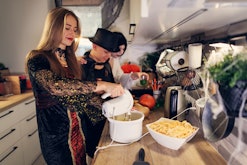 Mother and teenage kids are preparing food for Halloween party.

Canon R5
