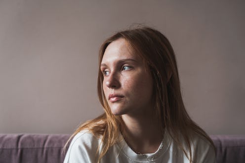 Teen depression. Portrait of sad upset redhead girl looking aside thinking about life problems, feel...