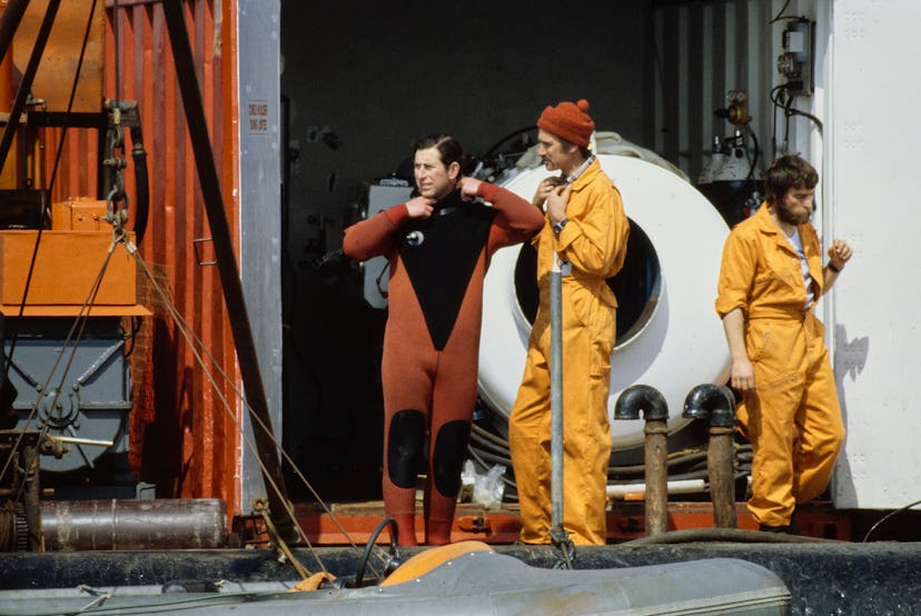 Prince Charles the President of the Mary Rose Trust, puts on a wetsuit in preparation for diving to ...