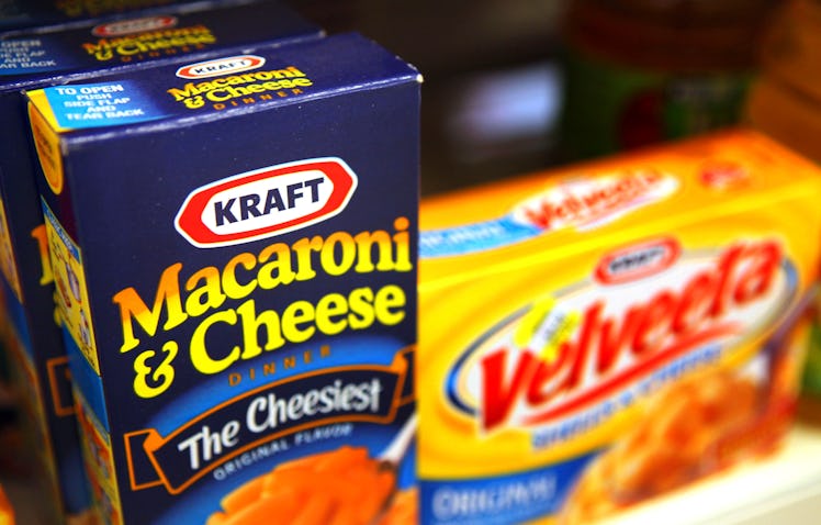Boxes of Kraft Foods Inc. Velveeta Shells & Cheese and Macaroni & Cheese sit on a shelf in a conveni...