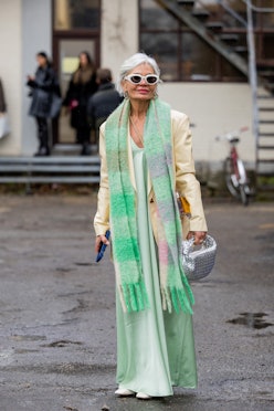 COPENHAGEN, DENMARK - JANUARY 31: Grece Ghanem wears mint green scarf, silk dress, mustard yellow bl...