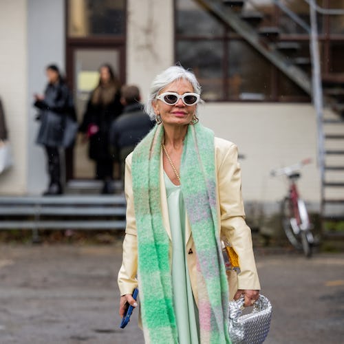 COPENHAGEN, DENMARK - JANUARY 31: Grece Ghanem wears mint green scarf, silk dress, mustard yellow bl...