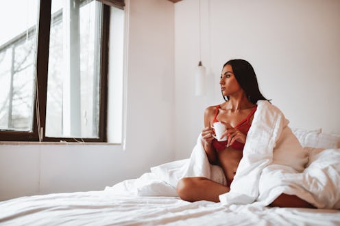 Beautiful Female Enjoying Morning Coffee In Bed