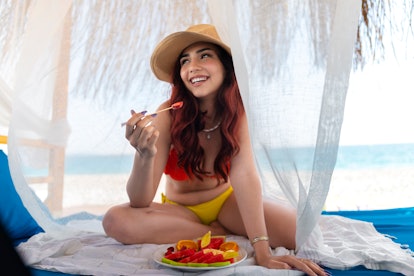 Young woman eating strawberry.