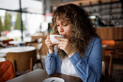 Young woman enjoying coffee at a cafe