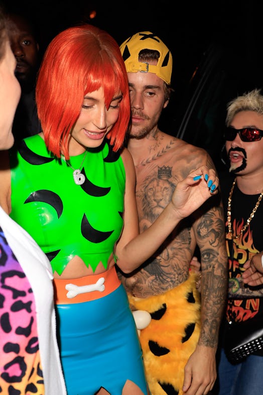 Justin Bieber and Hailey Bieber dressed as pebbles and bam bam from the filintstones on halloween