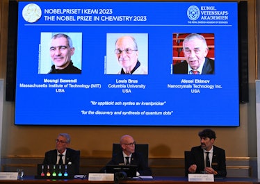A screen shows this year's laureates US Chemist Moungi Bawendi, US Chemist Louis Brus and Russian ph...