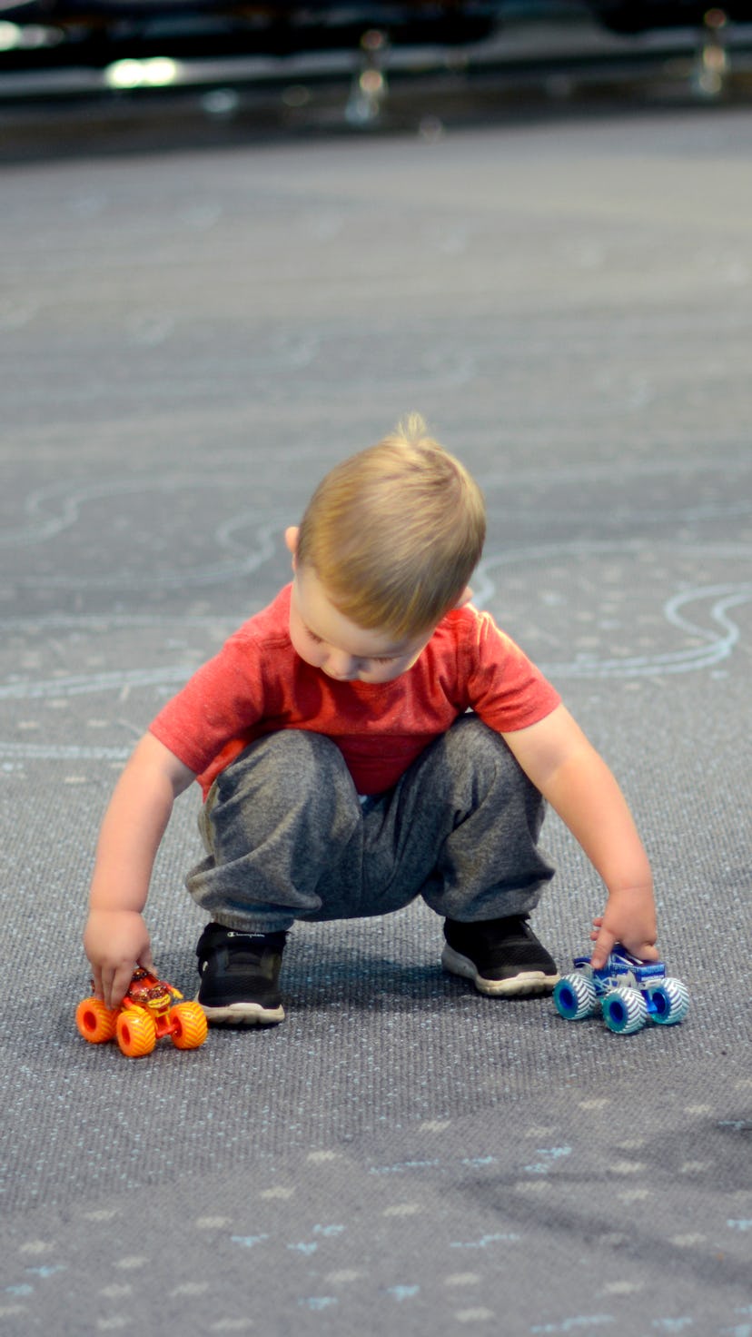DENVER, COLORADO - SEPTEMBER 1, 2019: A child plays with toys as his parents wait in the terminal wa...