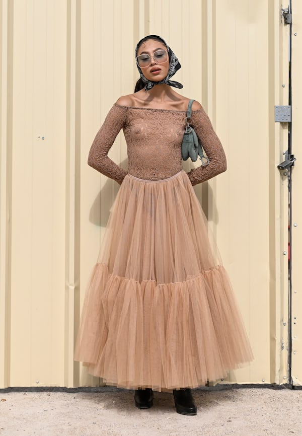 Imani is seen wearing a sheer Dior top and Dior tulle skirt with headscarf outside the Dior show dur...