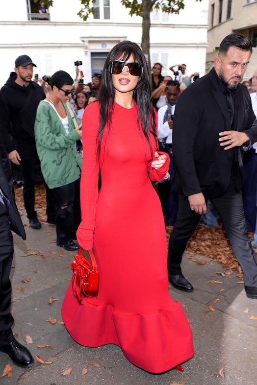 Kylie Jenner wears a red dress to attend the Acne Studios Womenswear Spring/Summer 2024 show. 