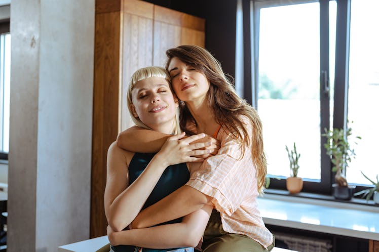 a young couple embraces as they consider the spiritual meaning of the 2023 "ring of fire" solar ecli...