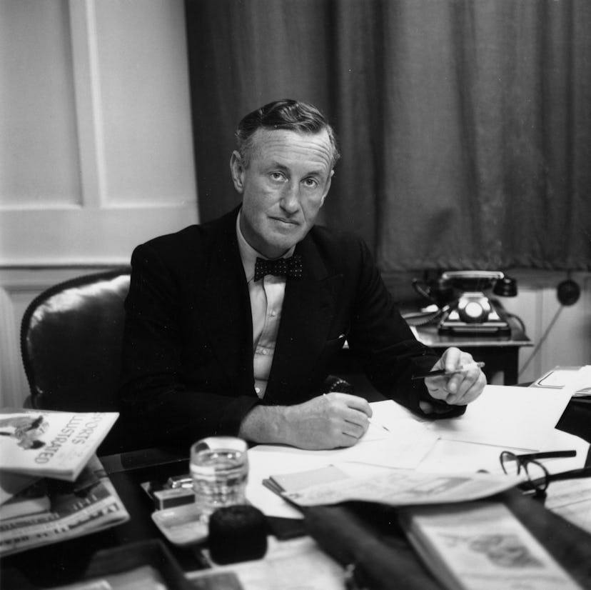 24th March 1958:  Ian Fleming, British author and creator of James Bond, at his desk in his study.  ...