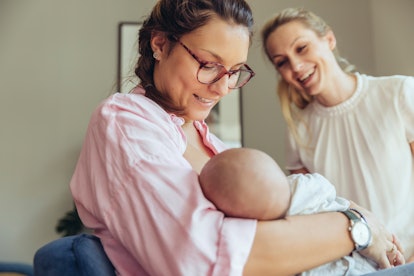 a women breastfeeds her baby with help from a lactation consultant, they're wondering about tongue t...