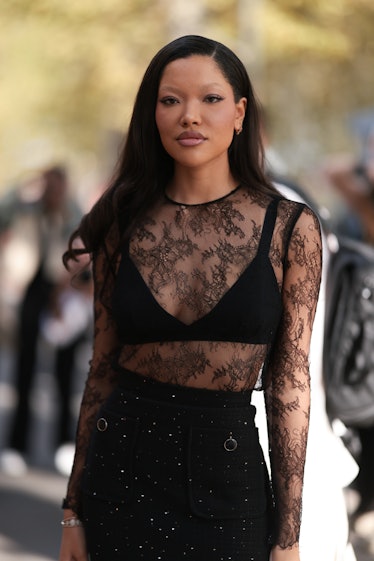 Ming Lee Simmons is seen wearing a black top with a long sleeve sheer lace top and a black skirt mad...