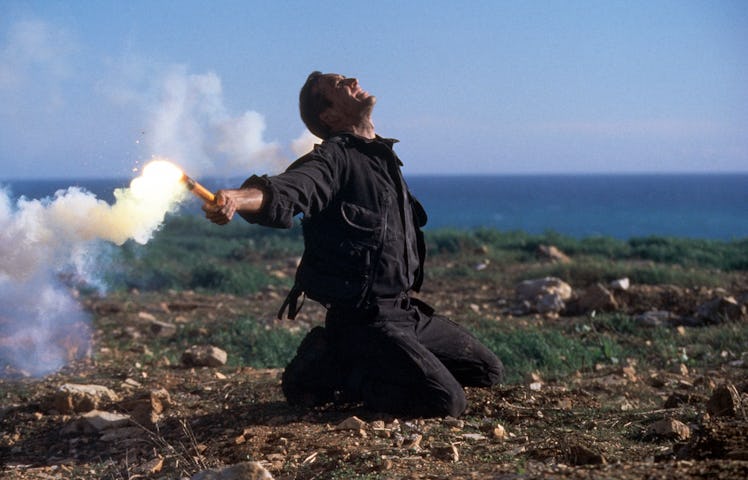 Nicolas Cage holds a flare in a scene from the film 'The Rock', 1996. (Photo by Buena Vista/Getty Im...