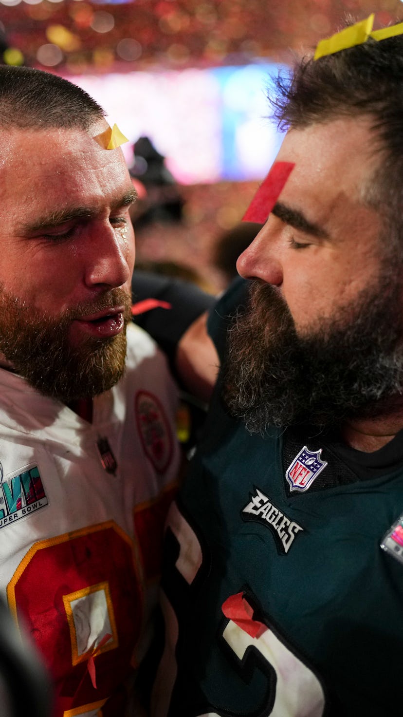 GLENDALE, AZ - FEBRUARY 12: Travis Kelce #87 of the Kansas City Chiefs speaks with Jason Kelce #62 o...