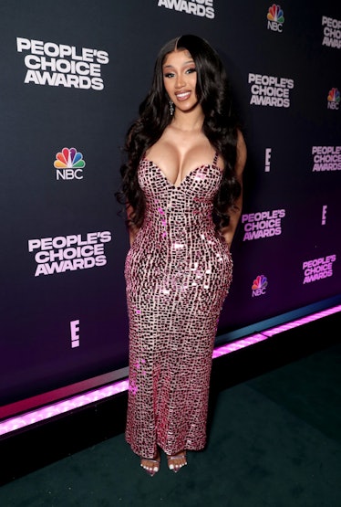 Cardi B poses in chanel cropped top and skirt