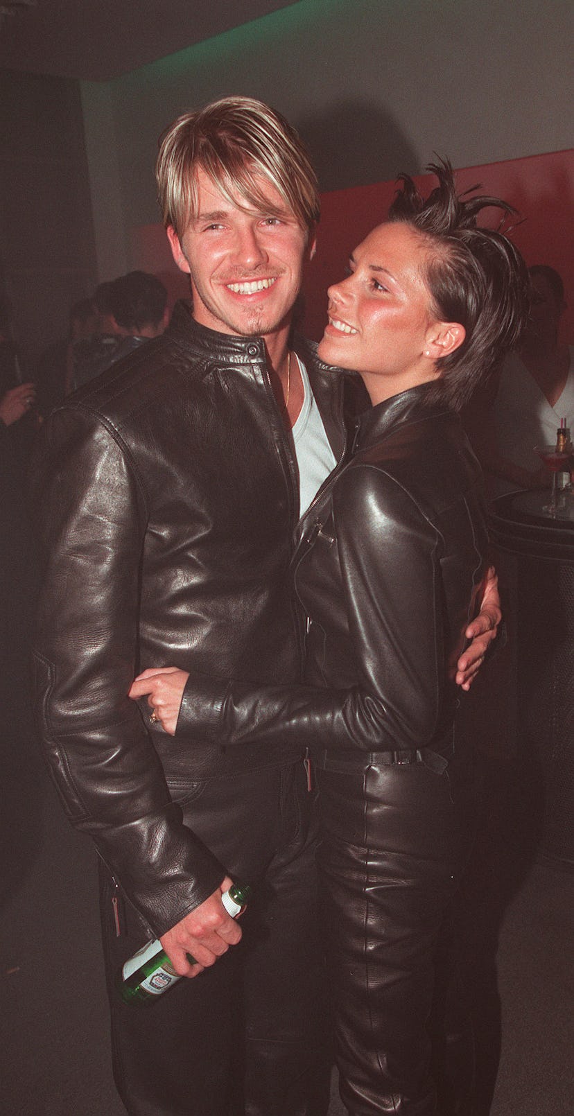 English soccer sensation David Beckham and singer Victoria 'Posh Spice' Adams embrace at the Versace...