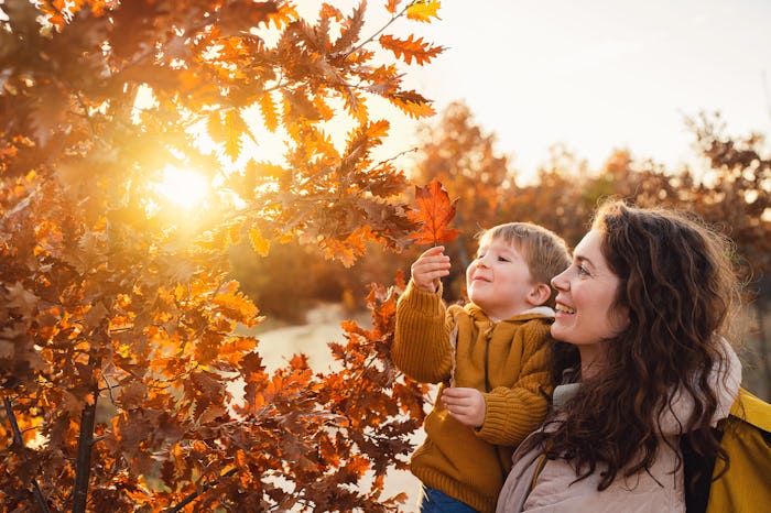 Mother and son enjoying a carefree autumn day in nature.