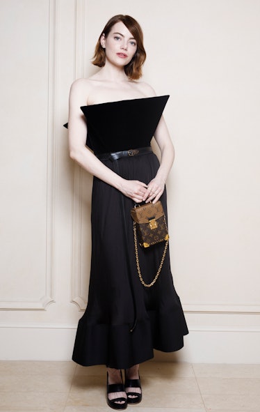 Emma Stone poses during a portrait session as she attends a Louis Vuitton private dinner at the Hote...