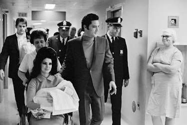 (Original Caption) 2/7/1968-Memphis, TN: Evis Presley with his wife and daughter as they leave Bapti...