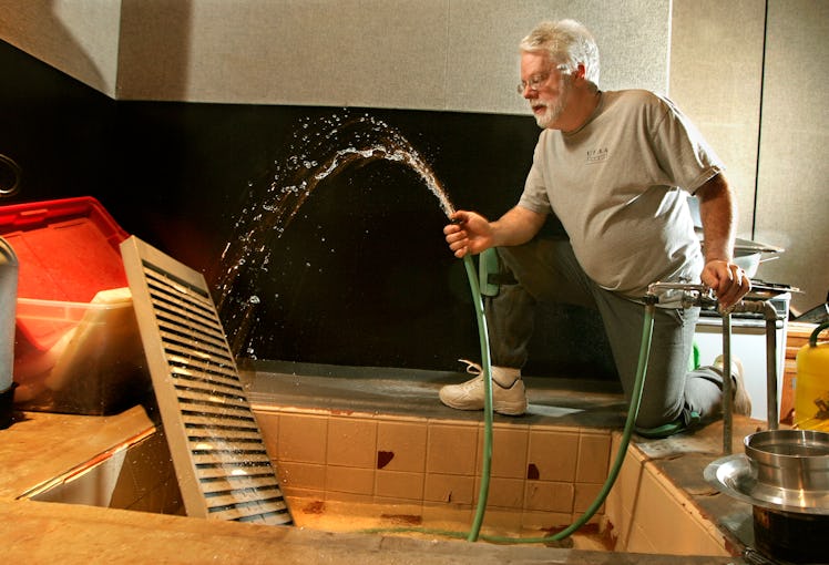Foley artist John Roesch, demonstrates spraying water against an old metal organizer to simulate the...