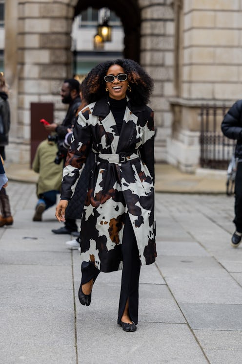 LONDON, ENGLAND - FEBRUARY 20: Naomi Elizée wears cow print belted coat outside Emilia Wickstead dur...