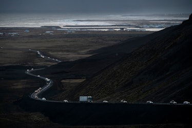 This photo taken on November 13, 2023 shows vehicles leaving the town of Grindavik, southwestern Ice...