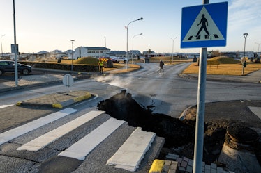 TOPSHOT - This photo taken on November 13, 2023 shows a crack cutting across the main road in Grinda...