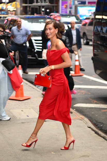 Hailey Bieber wears a red, off-the-shoulder dress to "Good Morning America."