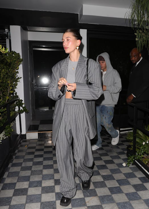 Hailey Bieber wears a pinstripe suit.