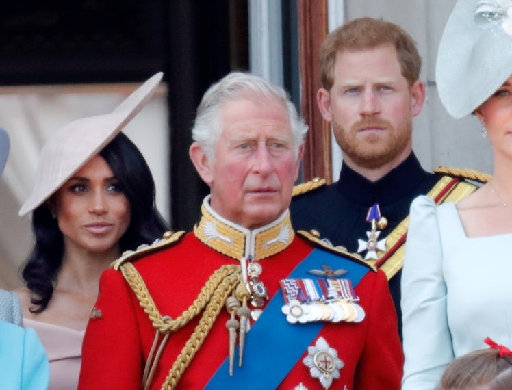 Meghan, Duchess of Sussex, Prince Charles, Prince of Wales and Prince Harry, Duke of Sussex stand on...
