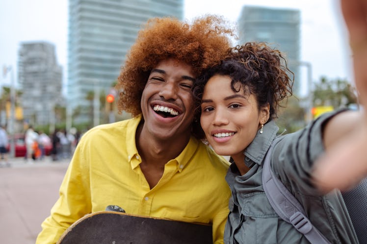 two young friends smile for a selfie as they consider the spiritual meaning of the November 2023 ful...