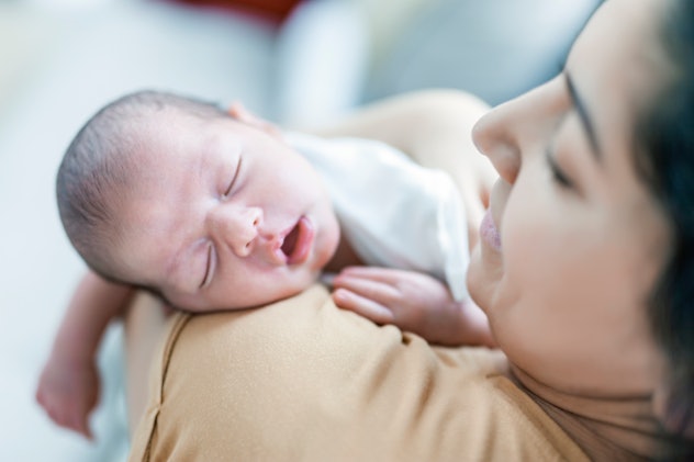 Newborn Baby Sleeping  in her mother's arms