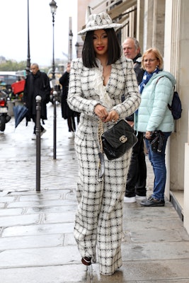 Cardi B wears a black-and-white tweed suit with a Chanel 19 bag. 