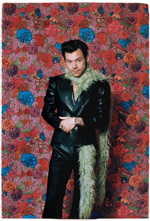 Harry Styles green scarf against floral background at 2021 grammys