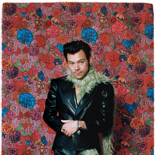 Harry Styles green scarf against floral background at 2021 grammys