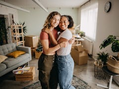 two friends embrace as they unpack their new apartment, and consider why December 9, 2023 will be th...