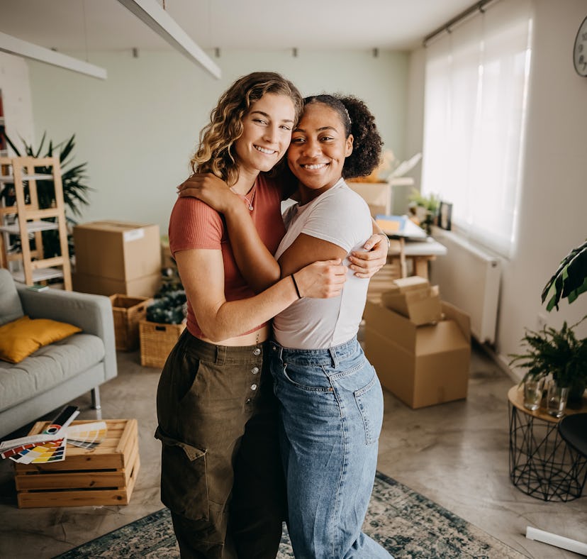 two friends embrace as they unpack their new apartment, and consider why December 9, 2023 will be th...