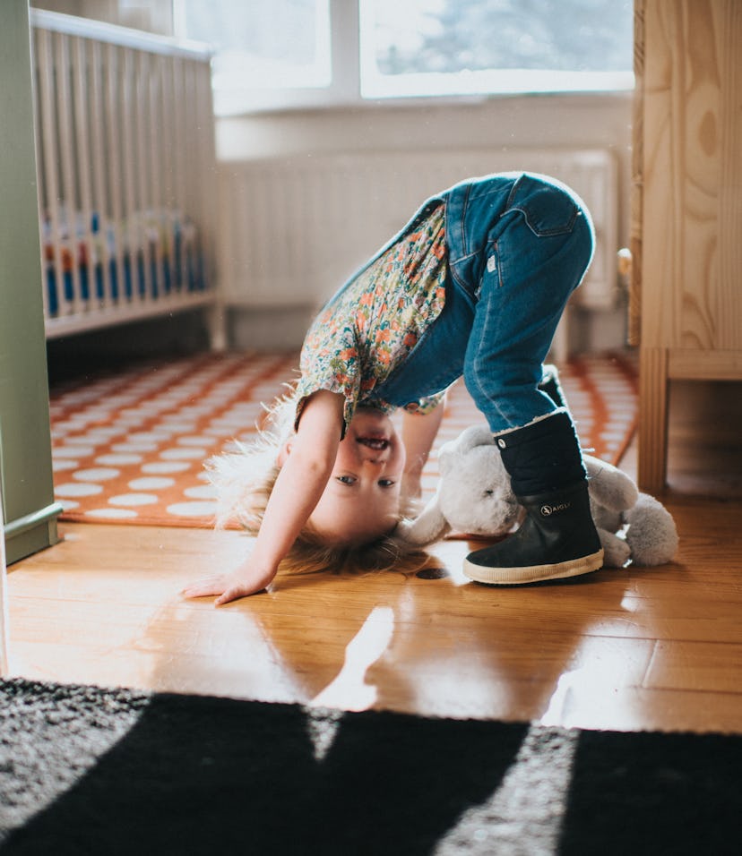 Sweet little playful tot, in a sunny bedroom