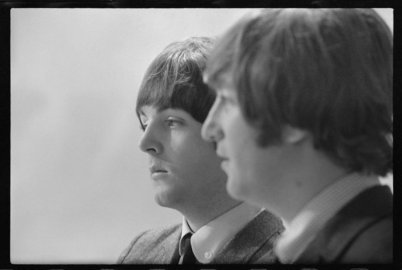 Musicians John Lennon (R) and Paul McCartney of English rock group The Beatles on the set of televis...