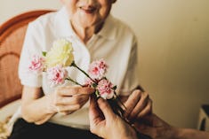 Japanese daughter is giving flower to her mother