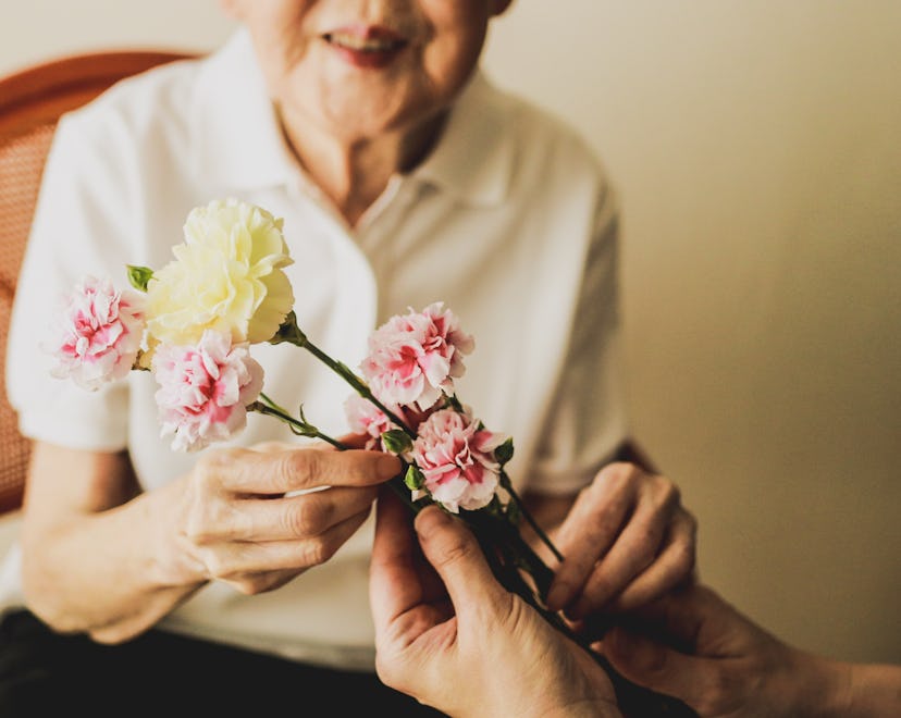Japanese daughter is giving flower to her mother