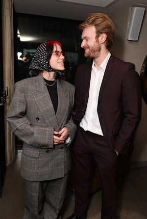 Billie Eilish wears a headscarf with a monogrammed suit with her brother Finneas O'Connell.