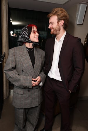 Billie Eilish wears a headscarf with a monogrammed suit with her brother Finneas O'Connell.