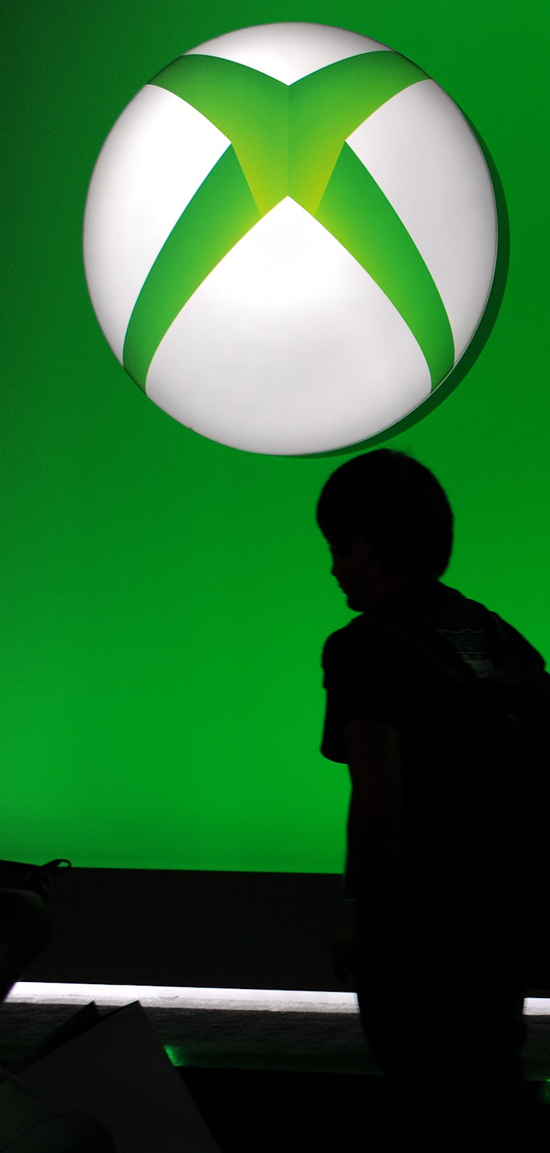 Attendees walk under the Microsoft Xbox One logo on the final day of the E3 Electronic Entertainment...