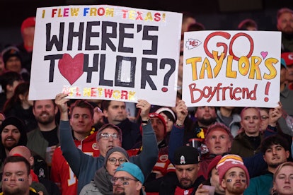 Fans hold up placards referring to Taylor Swift's boyfriend Kansas City Chiefs tight end Travis Kelc...